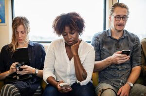 People Concentrating On Phones